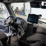 Electronic logging tablet and camera inside a parked commercial truck.